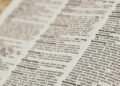 An open dictionary showing technology definitions, representing a beginner Bitcoin glossary