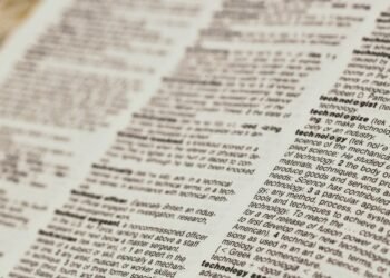 An open dictionary showing technology definitions, representing a beginner Bitcoin glossary