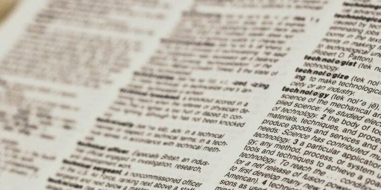 An open dictionary showing technology definitions, representing a beginner Bitcoin glossary