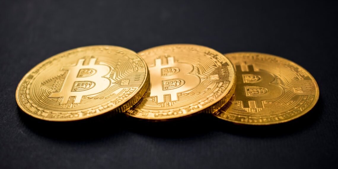 Three gold-colored Bitcoin coins representing the Bitcoin halving and shrinking mining rewards